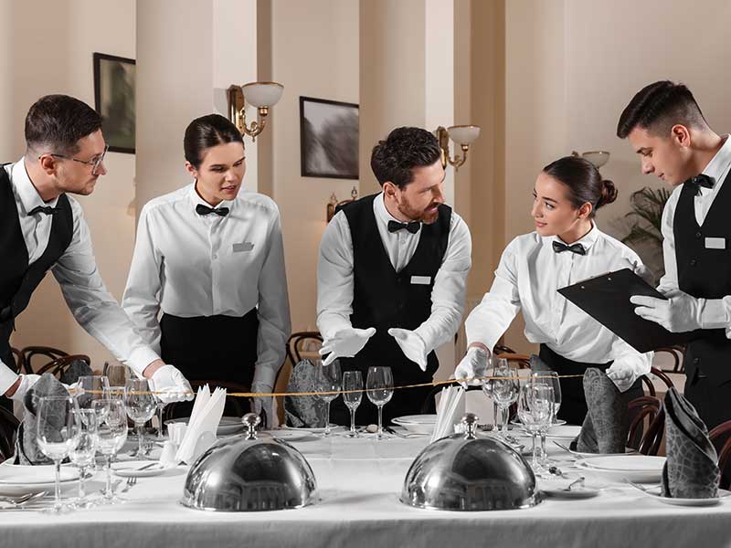 People setting table during professional butler courses